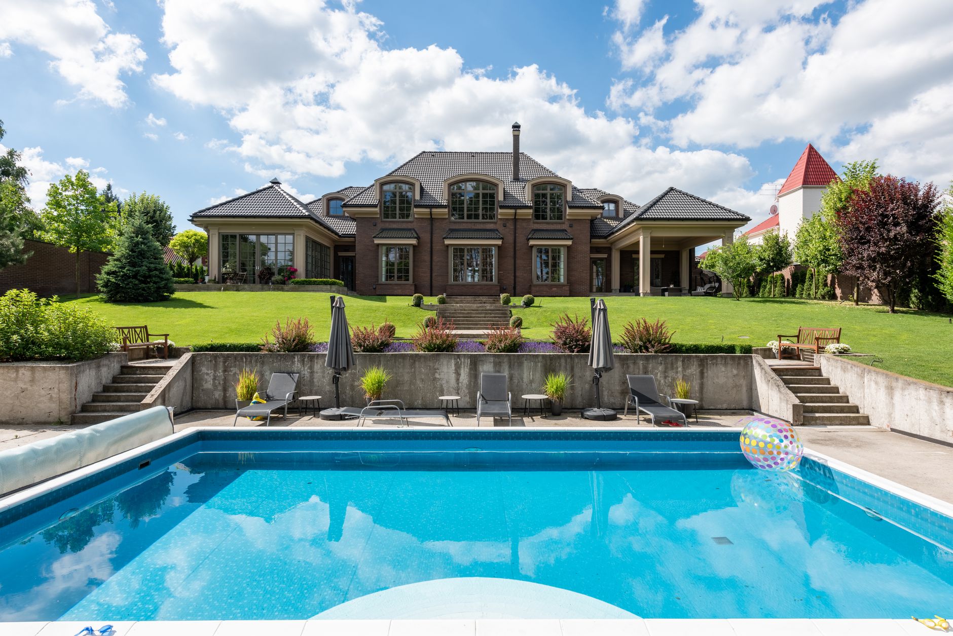 Elegant estate with custom inground pool and lush landscaping